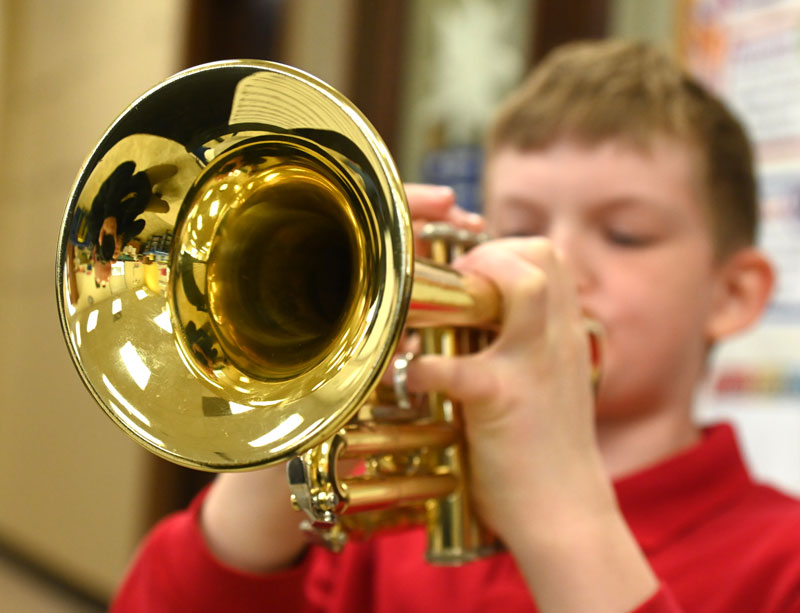 Student practices trumpet.