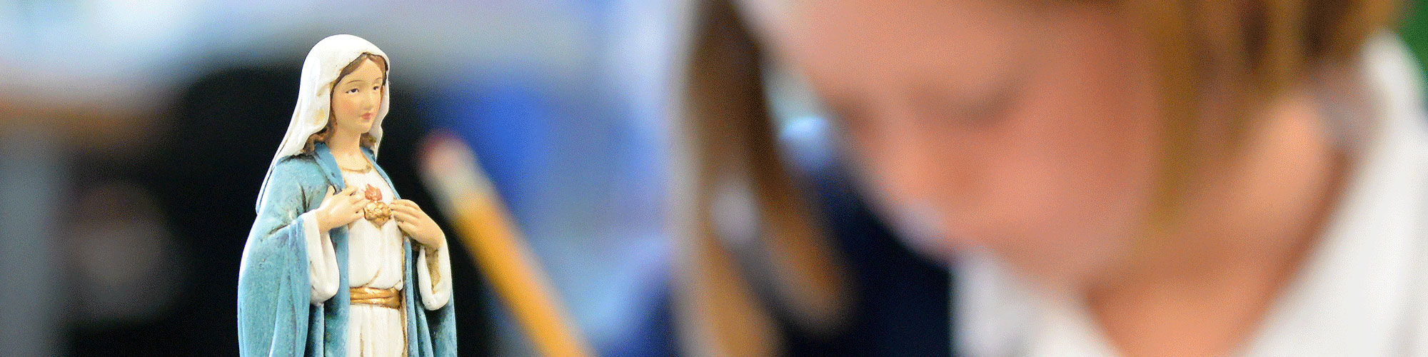 Statue of Mary in foreground.