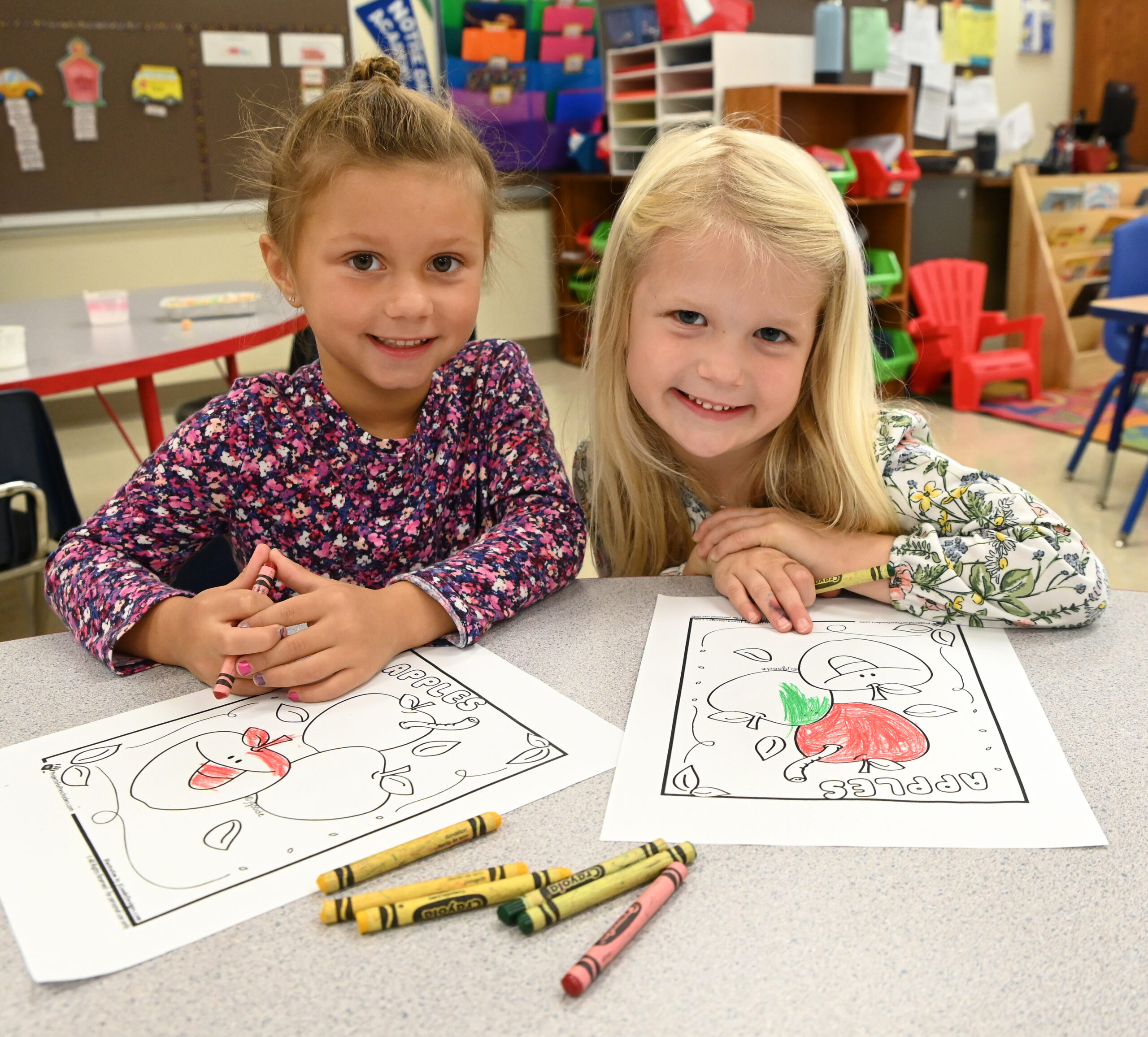 Two students work on coloring at Holy Cross School which is located near the Red Smith neighborhood.