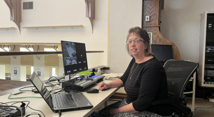 GRACE technology service member Lynn Fink at a computer desk.