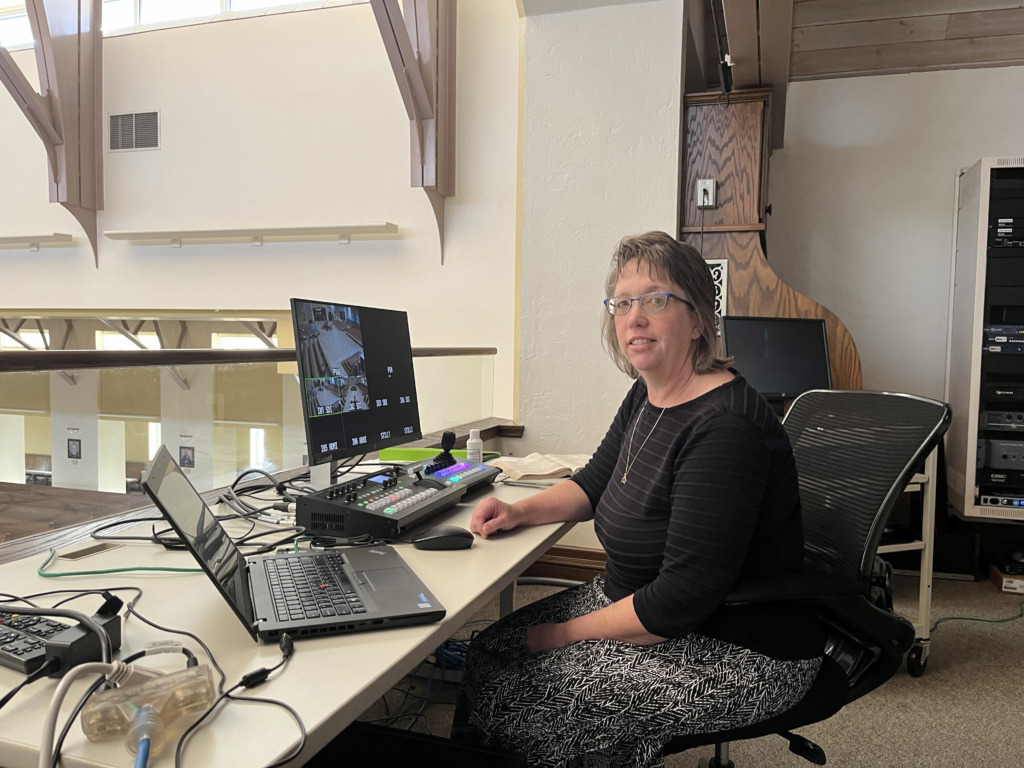 GRACE technology service member Lynn Fink at a computer desk.