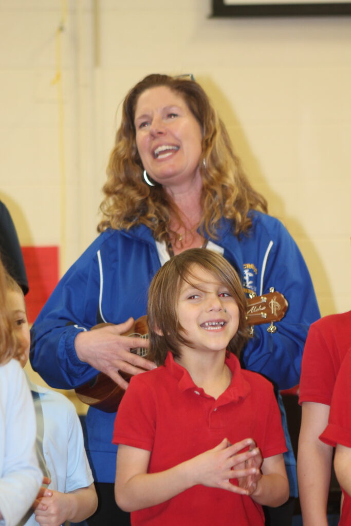Mrs. Anderson, Kindergarten teacher playing the ukulele 
