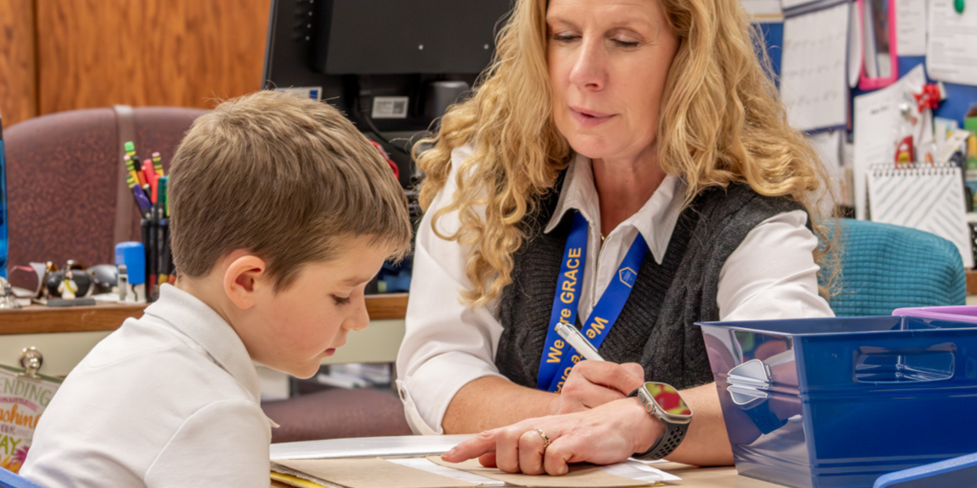 GRACE teacher pointing to assignment with student